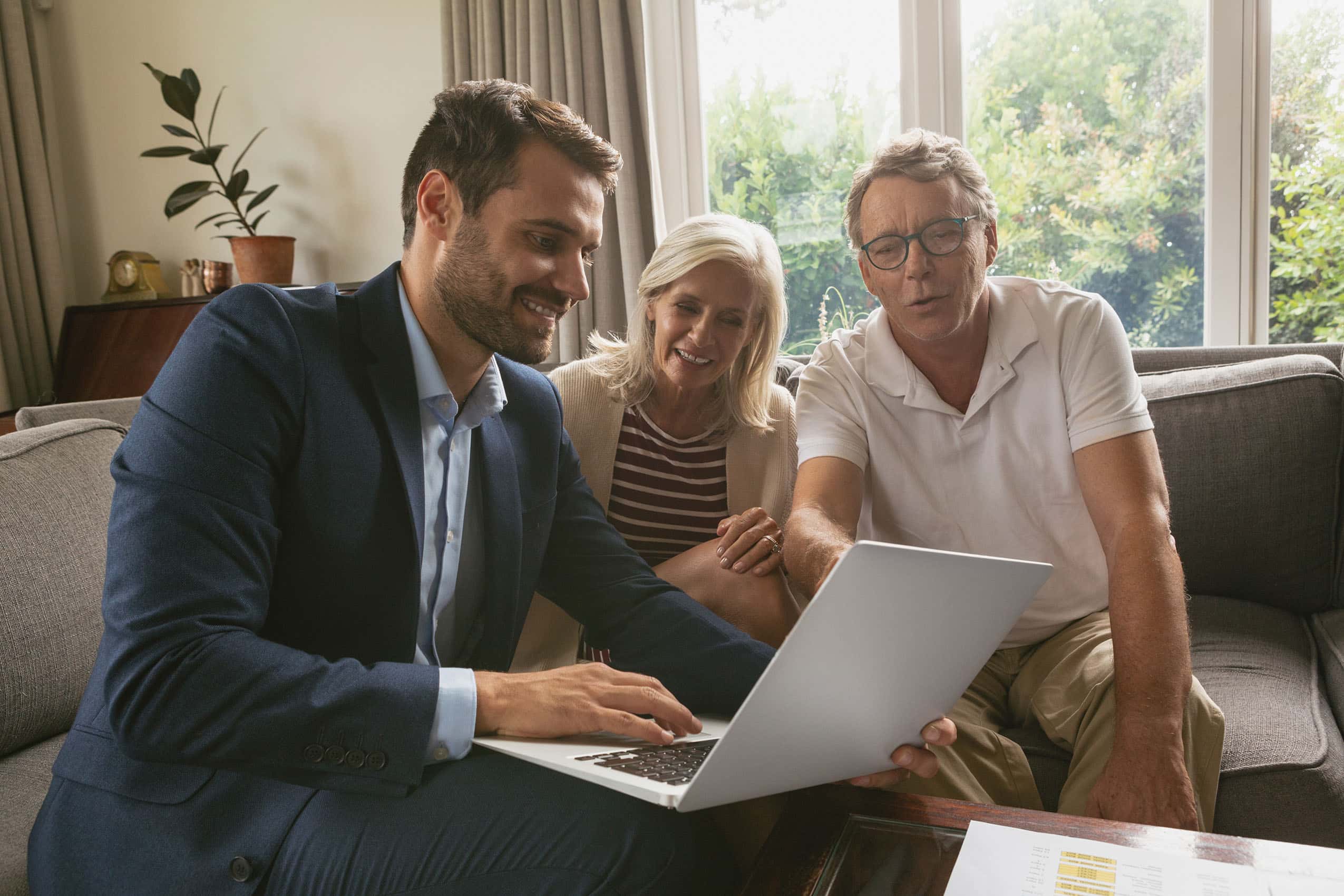 real-estate-agent-showing-computer-documents-to-clients