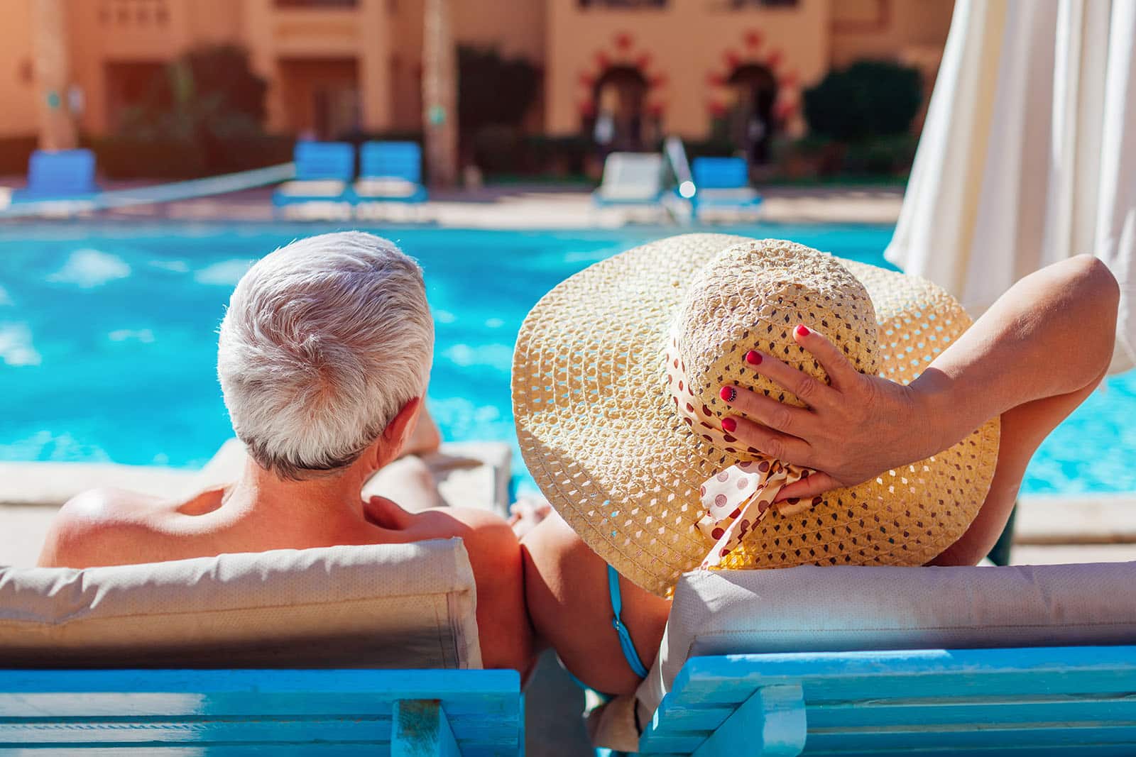 retired couple sitting by pool in rancho mirage